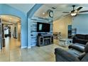 Inviting living room featuring a modern entertainment center and vaulted ceiling at 330 Chiquita Ct, Kissimmee, FL 34758