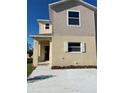 Charming two-story home featuring neutral siding, well-kept landscape, and a concrete driveway at 4855 Coral Castle Dr, Kissimmee, FL 34746