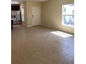 Bright, open-concept living area showcasing tile flooring and lots of natural light at 4855 Coral Castle Dr, Kissimmee, FL 34746