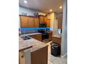 Well-equipped kitchen featuring wooden cabinets, modern appliances, and ample countertop space for cooking convenience at 4981 Alita Ter, St Cloud, FL 34769