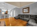 Open concept living room with hardwood floors, mirror and grey sectional at 4981 Alita Ter, St Cloud, FL 34769