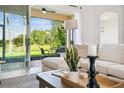 Cozy living space with comfortable seating and a view of the serene outdoor scenery at 517 Milano Rd, Poinciana, FL 34759