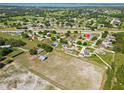 Wide aerial shot showing the home's location within a community near a serene lake at 6006 Country Walk Ln, Winter Haven, FL 33880