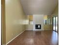 Spacious living room features hardwood floors, a vaulted ceiling, and a brick fireplace at 7200 Green Pine Ct, Orlando, FL 32819