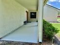 The well-lit front porch includes a bench and offers shelter with an overhang and painted concrete at 7200 Green Pine Ct, Orlando, FL 32819