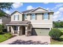 Attractive two-story home featuring brick-paved driveway and a well-maintained lawn and shrubbery at 7527 Marker Ave, Kissimmee, FL 34747