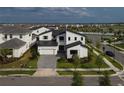 Gorgeous home features a two-car garage, modern design, and beautiful landscaping at 9004 Santorini Dr, Orlando, FL 32827
