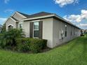 Exterior of a single-story home featuring a lush green lawn and well-maintained landscaping at 9318 Mclaren Aly, Winter Garden, FL 34787