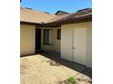 Exterior shot of a side door with concrete patio and textured walls at 940 Fenton Ln # 8, Lakeland, FL 33809