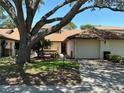 Charming one-story home with a large shade tree and attached one-car garage at 940 Fenton Ln # 8, Lakeland, FL 33809