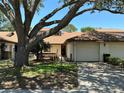 Charming one-story home with a large shade tree and attached one-car garage at 940 Fenton Ln # 8, Lakeland, FL 33809