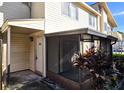 Charming condo entrance with a screened-in porch, attractive landscaping, and unit number 1024 at 1024 Spring Meadow Dr, Kissimmee, FL 34741