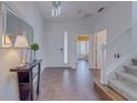 Welcoming foyer with wood floors, staircase, and a decorative table, creating an inviting entrance at 1101 Marcello Blvd, Kissimmee, FL 34746