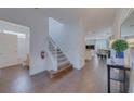 Inviting foyer with staircase, wood floors, and views of the dining and living areas at 1101 Marcello Blvd, Kissimmee, FL 34746