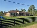 Charming one-story home with a well-maintained lawn and black wooden fence at 18805 Nettleton St, Orlando, FL 32833