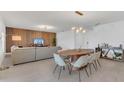 Open floor plan with living room and dining area with modern lighting and neutral color palette at 374 Pine Tree Bridge Trl, St Cloud, FL 34772