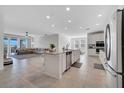 Open-concept kitchen featuring a spacious island, stainless steel appliances, and seamless flow to living area at 3844 Cabo Rojo Dr, St Cloud, FL 34772