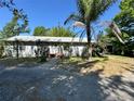 Cozy single-story home with a front walkway and lush, mature trees at 429 Diamond Acres Rd, Davenport, FL 33837