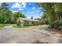 Charming single-story home with a neutral exterior, well-maintained landscaping, and a circular driveway at 429 Diamond Acres Rd, Davenport, FL 33837