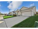 Well-maintained home featuring a two-car garage, driveway, green lawn and manicured landscaping at 4324 Desert Rose, Kissimmee, FL 34746