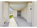 Inviting covered front porch with a gray front door, recessed lighting, and neutral color palette at 4324 Desert Rose, Kissimmee, FL 34746