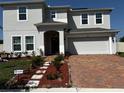 Charming two-story home featuring a brick paved driveway and inviting entrance at 4804 Marcos Cir, Kissimmee, FL 34758