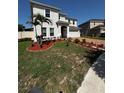 Well-maintained front yard featuring fresh mulch and beautiful landscaping at 4804 Marcos Cir, Kissimmee, FL 34758