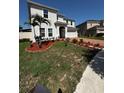 Well-maintained front yard featuring fresh mulch and beautiful landscaping at 4804 Marcos Cir, Kissimmee, FL 34758