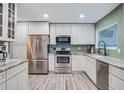 Bright eat-in kitchen featuring white cabinets, granite counters, and stainless appliances at 483 Stillwater Dr, Oviedo, FL 32765