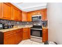 Well-organized kitchen featuring stainless steel appliances and granite countertops at 502 Engel Dr, Orlando, FL 32807