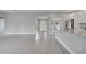 Open-concept living area featuring stylish tile flooring, a bright airy space with an open kitchen at 502 Viceroy Ct, Kissimmee, FL 34758
