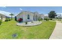 Well-manicured lawn and landscaping surround this beautiful single-story home at 520 Prestwick Dr, Davenport, FL 33897