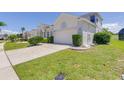 This single story house includes a paved driveway and attached two car garage at 520 Prestwick Dr, Davenport, FL 33897