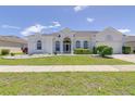 Charming single-story home with a manicured lawn and well-maintained landscaping at 520 Prestwick Dr, Davenport, FL 33897