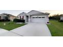 Beautiful single-Gathering home with a wide driveway, stone accents, and holiday decorations at 5306 Meadow Song Dr, Okahumpka, FL 34762