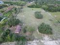 Sprawling aerial view of a home on a large lot with mature trees, highlighting privacy and natural surroundings at 6100 Skokie Rd, Lake Wales, FL 33898