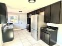 Bright kitchen with stainless steel appliances, ample cabinetry, and tiled flooring at 6100 Skokie Rd, Lake Wales, FL 33898