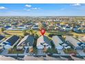 Aerial view of a single-Gathering home showcasing well-manicured lawns and neighborhood at 620 Old Bridge Cir, Davenport, FL 33897