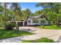 Charming two-story home with lush landscaping, mature trees, and a two car garage at 650 Main St, Altamonte Springs, FL 32701
