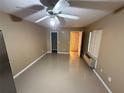 Bright living room featuring tiled flooring, a ceiling fan, and large window offering natural light at 709 Orchid Dr, Davenport, FL 33897