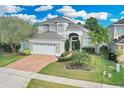 Inviting two-story home featuring a manicured lawn and a charming facade at 721 Hardwood Cir, Orlando, FL 32828