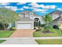 Inviting two-story home featuring a manicured lawn and a charming facade at 721 Hardwood Cir, Orlando, FL 32828