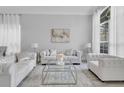 Elegantly furnished living room with plush seating and abundant natural light at 721 Hardwood Cir, Orlando, FL 32828
