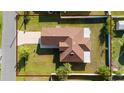 Overhead view of home showcasing roof, yard, and lot with adjacent street at 802 Massy Ct, Kissimmee, FL 34759