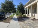 A well-manicured lawn and sidewalk lead to the front of this lovely residential home at 8270 Topsail Pl, Winter Garden, FL 34787