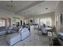 Open-concept living and dining area featuring modern finishes, high ceilings, and marble flooring at 8270 Topsail Pl, Winter Garden, FL 34787