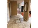 Inviting entryway featuring tile floors, staircase, and a decorative mirror at 878 Elgin Dr, Winter Springs, FL 32708