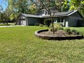 Charming home featuring a two-car garage, solar panels, and well-maintained landscaping at 878 Elgin Dr, Winter Springs, FL 32708
