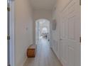 Bright hallway features wood-look floors, fresh white walls and a decorative wicker accent piece at 926 Balmoral Dr, Davenport, FL 33896