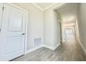 Bright hallway featuring modern flooring, recessed lighting, and access to multiple rooms at 1001 Umbria Dr, Poinciana, FL 34759